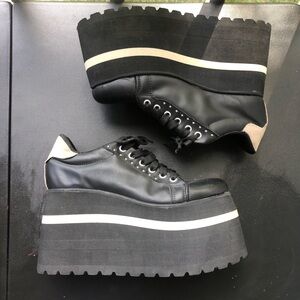 “Groovas” by Maddison black Black and tan platform sneakers with metal studs